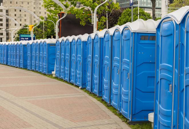 a row of portable restrooms set up for a large athletic event, allowing participants and spectators to easily take care of their needs in Boynton Beach